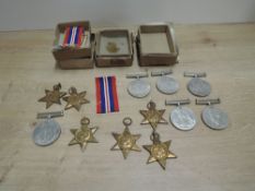 A collection of WWII Medals in three card issued boxes with papers, 1939-45 Star x3, Defence Medal