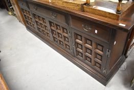 A mid to late 20th Century oak sideboard having cushion panelled doors, width approx. 207cm