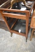 A mid 20th Century teak and smoked glass tea trolley