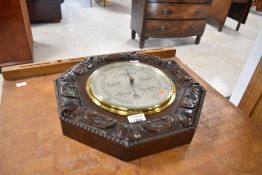 An early 20th Century oak cased aneroid barometer , named for W T Story, Barrow, width approx. 37cm