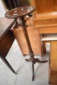A mid to late 20th Century mahogany jardiniere stand on turned column and triple splay legs