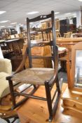 A Victorian rush seated rocking chair