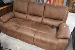A modern brown suede three seater settee