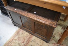 An early 20th Century oak panelled bedding box, width approx. 91cm