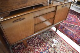A mid 20th Century mahogany sideboard on stylised legs, width approx. 128cm