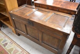 A traditional dark stained pine coffer, dimensions approx. W120 D50 H67cm