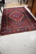 A traditional Persian rug, approx 210 x 140cm