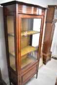 An Edwardian mahogany display cabinet, having cupboard to base, approx dimensions H180 W75 D40cm