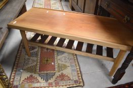 A vintage teak or sapele coffee table having slatted undertier, width approx. 112cm