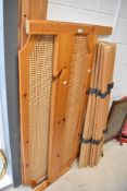 A modern pine double bedframe with bergere canework ends and wooden slats, overall width approx.