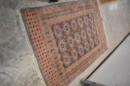 A Persian/Belgian style rug, having pink ground, with blue highlights, approx. 173 x 125cm