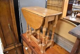 A vintage stained pine drop leaf occasional table