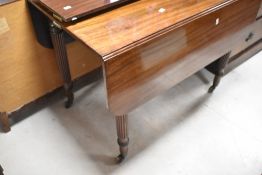 A Victorian mahogany extending dining table in the Gillows style having drop flaps and fluted