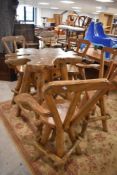 An unusual teak root wood bar table and four similar swivel chairs