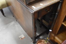 An early to mid 20th Century oak drop leaf table, width approx. 107cm