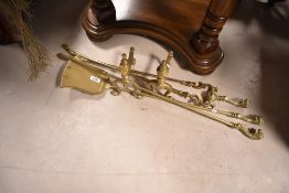 A pair of vintage brass fire dogs and three piece companion set , with lion finials