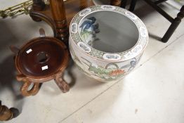 A reproduction Chinese fishbowl and stand