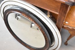 Two vintage oval wall mirrors