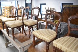 A set of six Victorian mahogany balloon back dining chairs having shaped rail and turned legs,