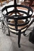 A cast iron torchere or plant stand
