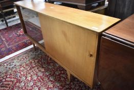 A vintage sapele low bookcase having glazed and solid doors, width approx. 155cm