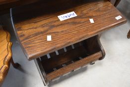 A mid to late 20th Century oak knitting table or magazine rack