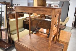 An Edwardian mahogany side table having inlaid decoration with draw to end, on tapered legs, approx.