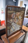 An antique tapestry firescreen
