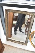 A modern wall mirror having silvered foliate finish, approx 86 x 60cm