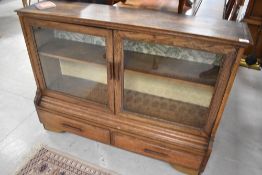 An early 20th Century oak bookcase having drawer base, dimensions approx. Width 117cm H86cm