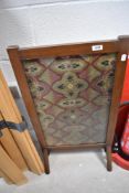 An Edwardian mahogany fire screen having tapestry inset