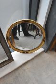 A vintage circular wall mirror , having gilt detailing, width approx. 52cm