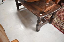 A dark stained coffee table on chunky legs, approx. 119 x 58cm