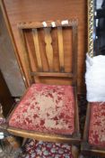 A set of four early 20th Century oak rail back dining chairs