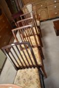 A set of three early 20th Century mahogany rail back chairs, another similar and a later carver