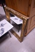 A gilt frame wall mirror having foliate decoration, approx. 69 x 57cm