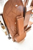 A traditional African Palaver chair having carved elephant decoration together with a further
