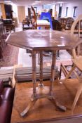 A late Victorian octagonal occasional table with three turned supports and trefoil base 71cm