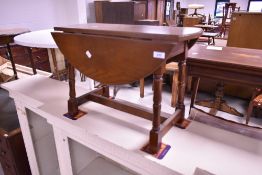 A mid to late 20th Century oak drop leaf occasional table, width approx. 60cm