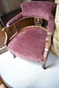 A Victorian salon style low easy chair on turned legs