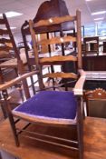 An early 20th Century stained frame ladderback carver chair