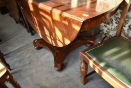 A William IV mahogany drop leaf dining table on typical platform base with bun feet