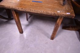 A 1940's oak draw-out dining table, of square outline with shaped supports, 74cm high