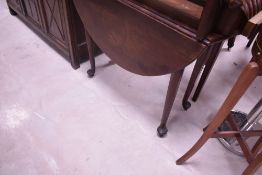 A 19th century mahogany drop leaf table, of traditional design with demi-lune flaps and turned