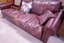 A contemporary burgundy leather 'Hide and Chic' settee, 214cm