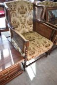 A late 19th or early 20th Century three piece lounge suite having oak twist frae, bergere cane sides