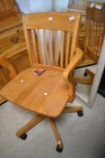 A modern rubber wood revolving office chair
