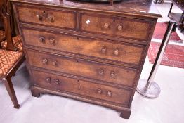 A 19th century mahogany banded oak chest of two over three long graduating drawers, each with