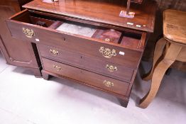 A 19th Century mahogany chest of four long drawers, the top drawer concealing compartmental interior