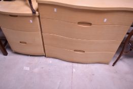 A modern serpentine fronted lightwood effect three drawer chest 79cm x 87cm, sold together with a